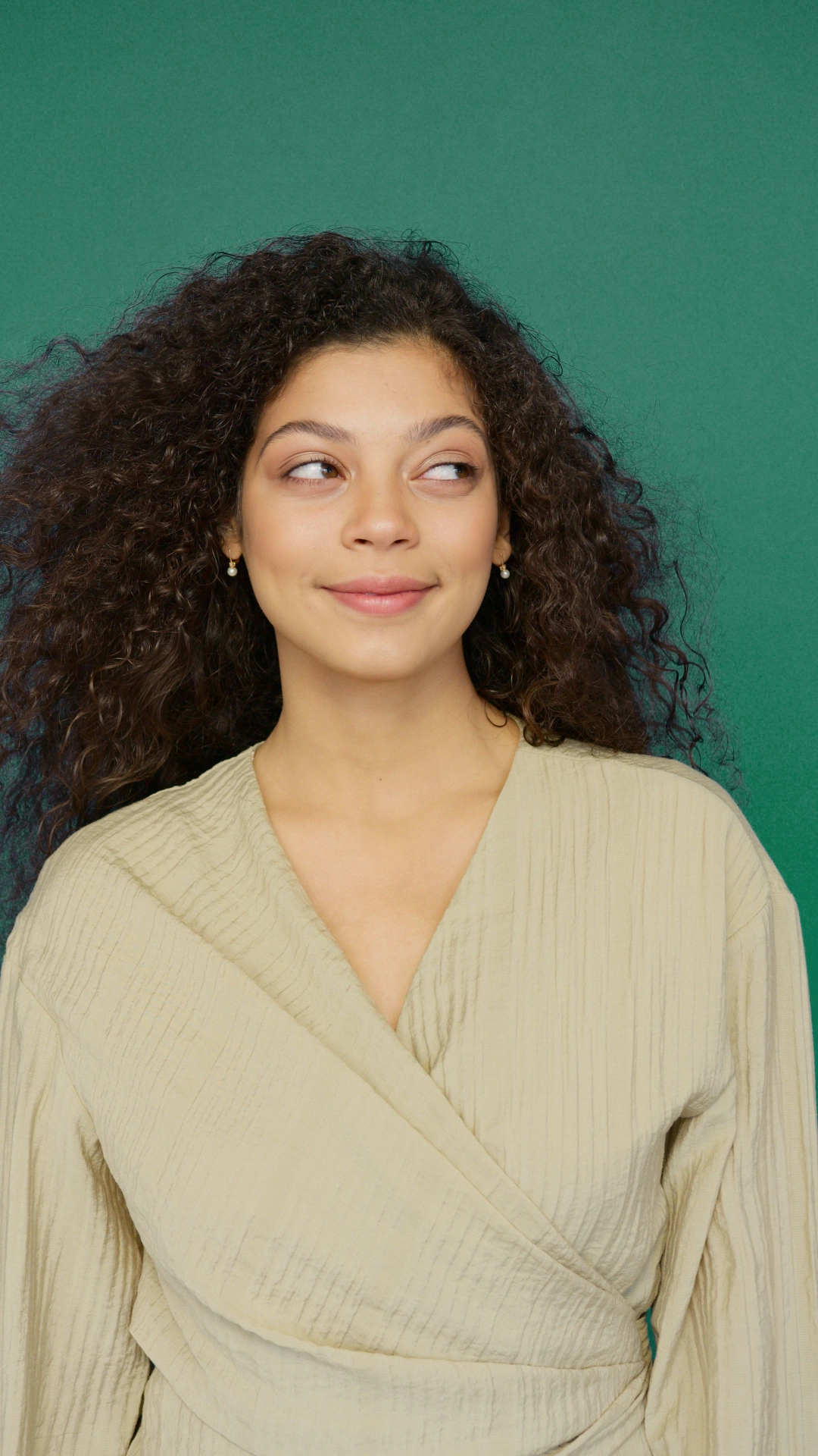 A woman looking thoughtfully into the distance.