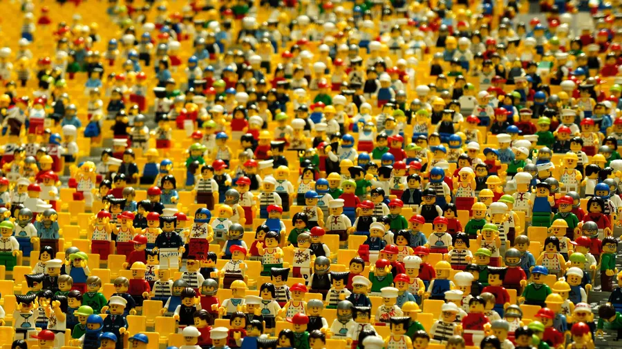 A vast crowd of Lego minifigures packed together, every one of them looking slightly different.