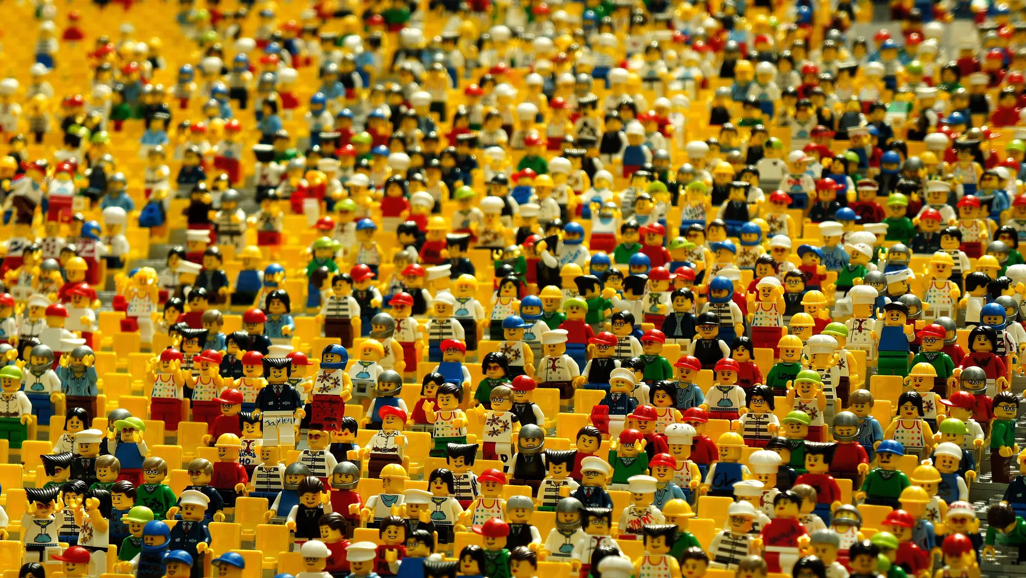 A vast crowd of Lego minifigures packed together, every one of them looking slightly different.