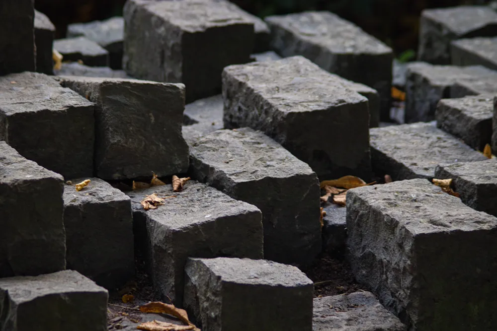 Neatly stacked cut stone blocks forming a solid structure.