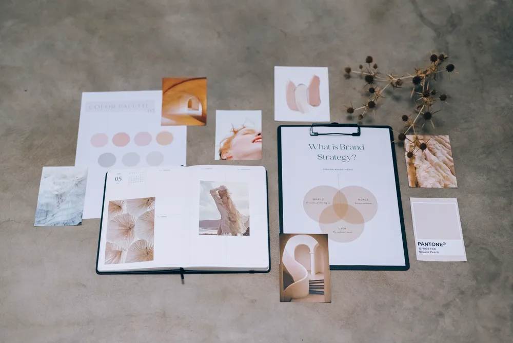 A flat-lay brand strategy moodboard with a colour palette and a page titled What is Brand Strategy.