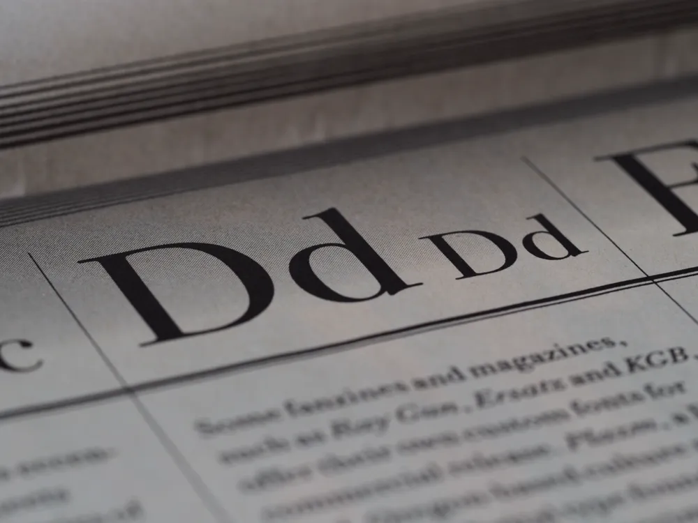 Close-up of a printed page showing the letter D set in several typefaces.