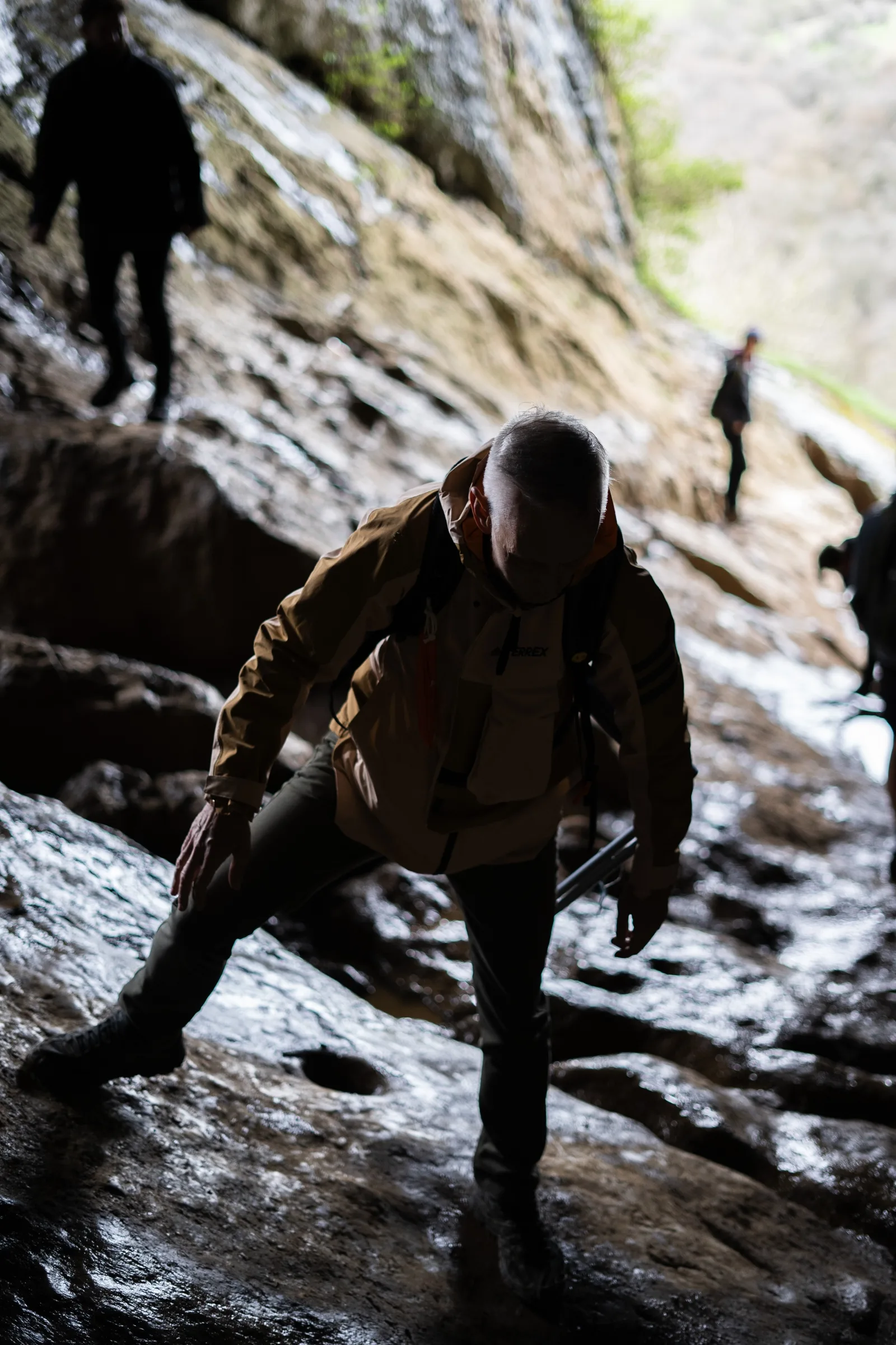 A 9 Wanders group hiker climbing rock at Thor's Cave